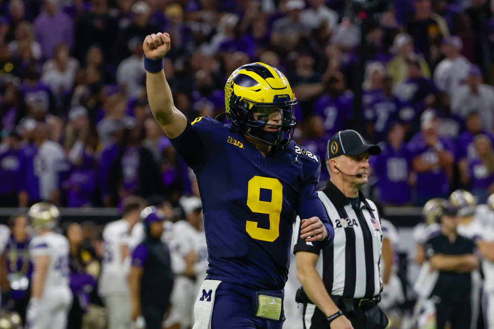 Michigan Wolverines quarterback J.J. McCarthy (9) holds his arm up after another Michigan touchdown during the CFP National Championship game Michigan Wolverines and Washington Huskies on January 8, 2024, at NRG Stadium in Houston, Texas.