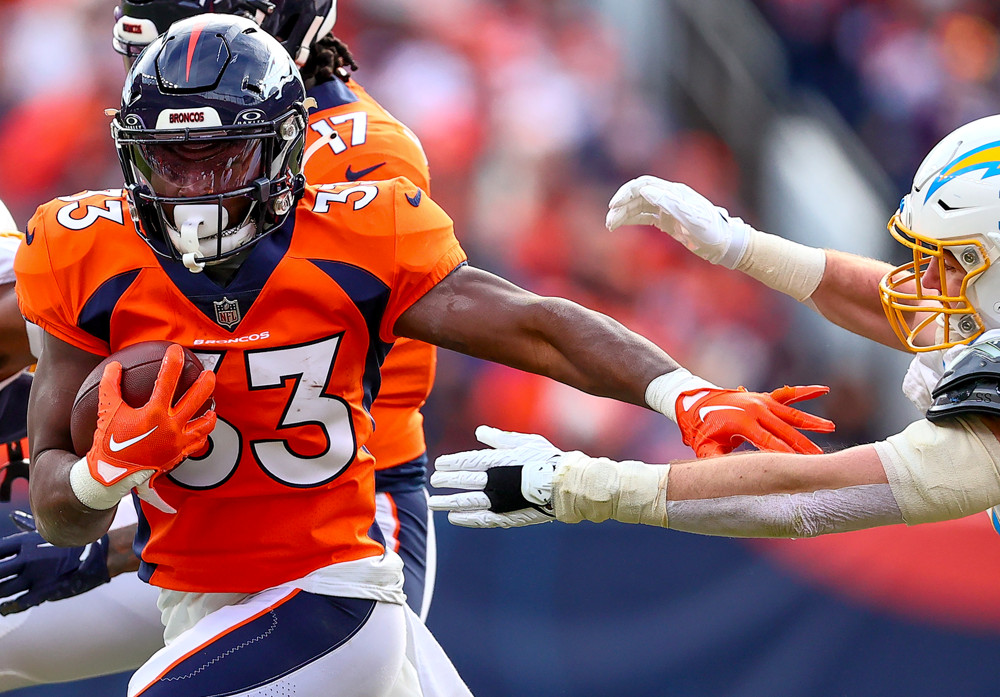 Denver Broncos running back Javonte Williams (33) avoids get stopped during an NFL game between the Los Angeles Chargers and the Denver Broncos on December 31, 2023 at Empower Field at Mile High in Denver, CO.