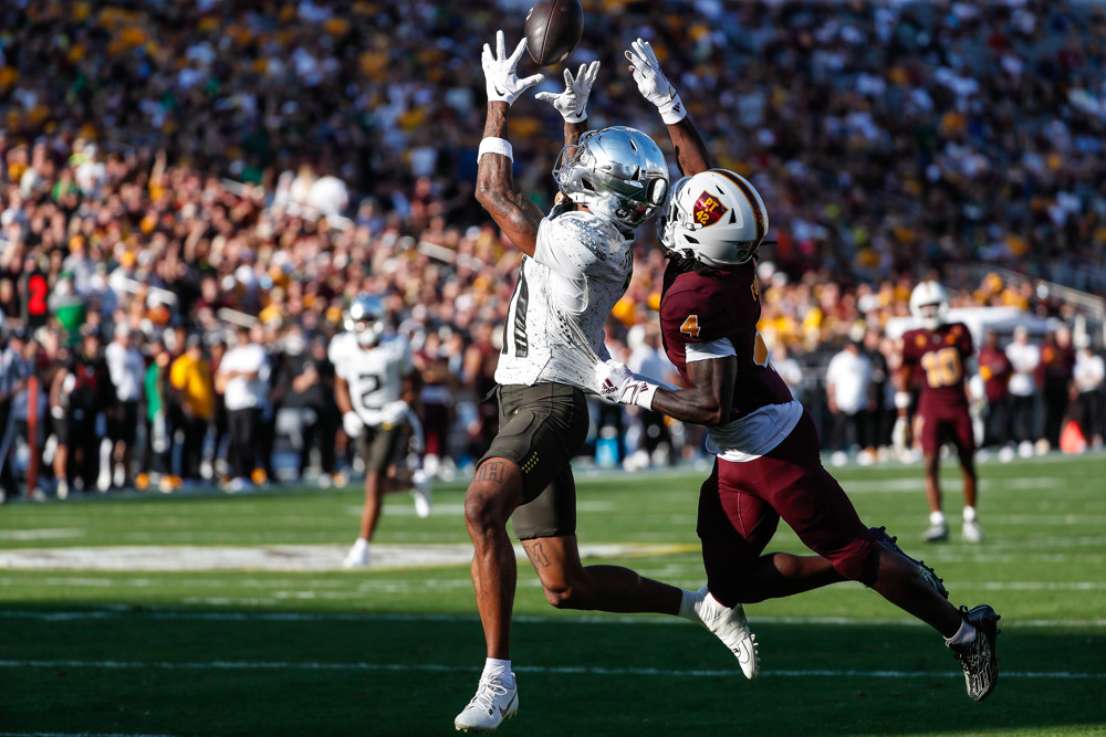 Oregon Ducks wide receiver Troy Franklin (11) catches a touchdown pass defended by Arizona State Sun Devils defensive back Demetries Ford (4) during the college football game between the Oregon Ducks and the Arizona State Sun Devils on November 18, 2023 at Mountain America Stadium in Tempe, Arizona.