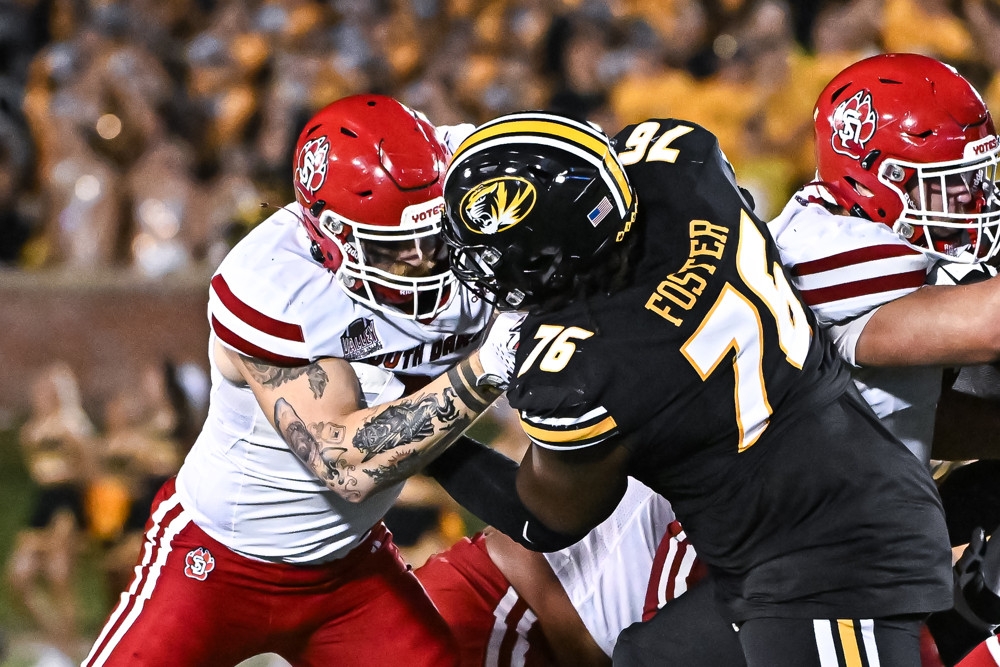 South Dakota Coyotes defensive lineman Brendan Webb (91) and Missouri Tigers offensive lineman Javon Foster (76) battle at the line during a non conference game between the South Dakota Coyotes and the Missouri Tigers held on Thursday Aug 31, 2023 at Faurot Field at Memorial Stadium in Columbia MO.