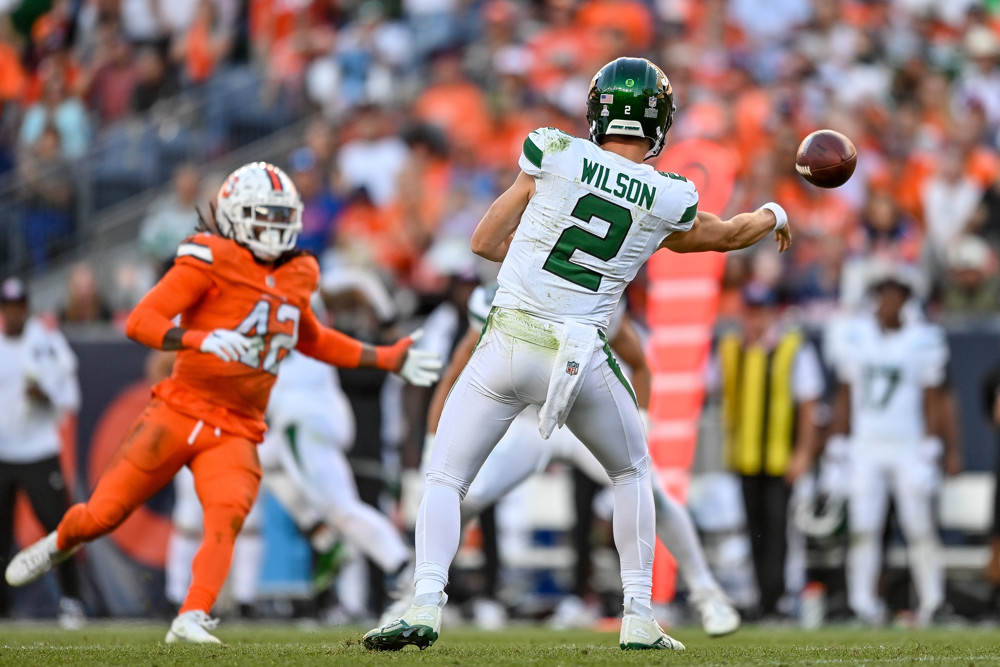 New York Jets quarterback Zach Wilson (2) slings a sidearm pass in the fourth quarter during a game between the New York Jets and the Denver Broncos at Empower Field at Mile High on October 8, 2023 in Denver, Colorado.