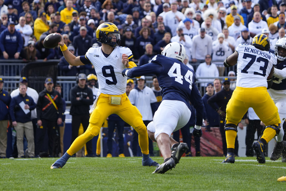 Michigan Wolverines Quarterback J.J. McCarthy (9) throws the ball with Penn State Nittany Lions Defensive End Chop Robinson (44) applying pressure during the first half of the College Football game between the Michigan Wolverines and the Penn State Nittany Lions on November 11, 2023, at Beaver Stadium in University Park, PA. 