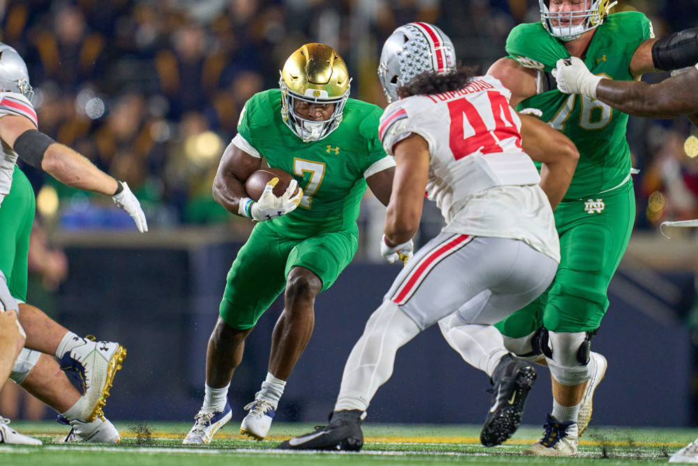 Denver Broncos running back Audric Estime (7) battles with Ohio State Buckeyes defensive end JT Tuimoloau (44) in action during a football game between the Notre Dame Fighting Irish and the Ohio State Buckeyes on September 23, 2023 at Notre Dame Stadium in South Bend, IN.