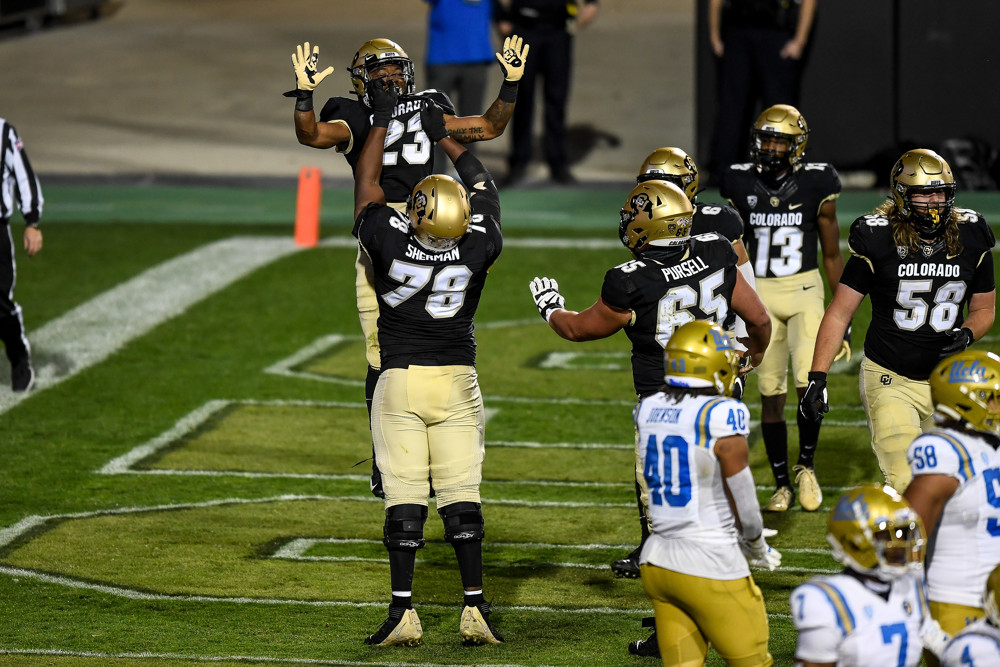 Running back Jarek Broussard (23) is lifted in the air by Colorado Buffaloes offensive lineman William Sherman (78) after a second quarter touchdown during a PAC 12 conference game between the Colorado Buffaloes and the UCLA Bruins at Folsom Field in Boulder, Colorado. 
