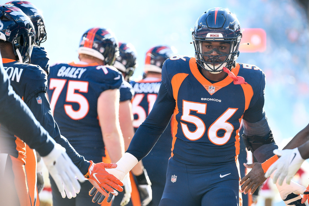 Denver Broncos linebacker Baron Browning (56) runs onto the field during player introductions before a game between the Kansas City Chiefs and the Denver Broncos at Empower Field at Mile High on December 11, 2022 in Denver, Colorado.