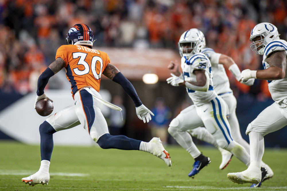 Denver Broncos safety Caden Sterns (30) runs with the ball after intercepting a pass in the second quarter of an NFL game between the Indianapolis Colts and the Denver Broncos at Empower Field at Mile High on October 06, 2022 in Denver, Colorado.