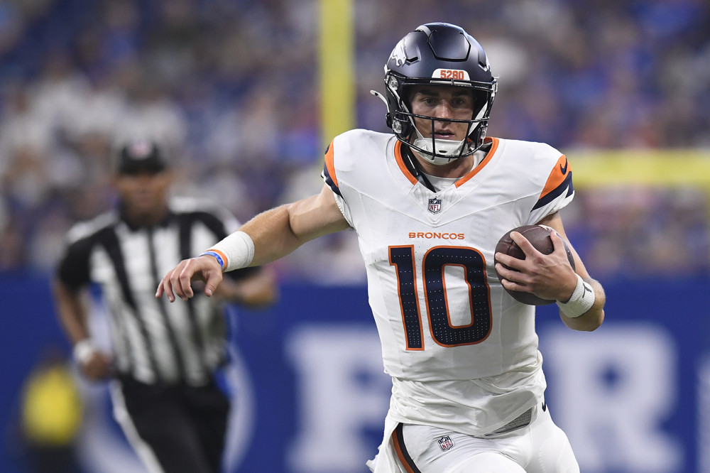 Denver Broncos Quarterback Bo Nix (10) scrambles during the NFL Preseason game between the Denver Broncos and the Indianapolis Colts on August 11, 2024, at Lucas Oil Stadium in Indianapolis, Indiana.