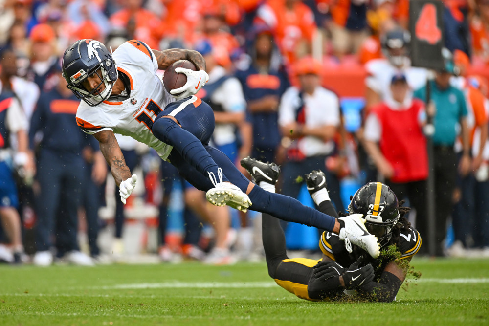 Denver wide receiver Josh Reynolds (11) runs the ball and is pulled down by Pittsburgh cornerback Cory Trice Jr. (27) during a game between the Denver Broncos and the Pittsburgh Steelers at Empower Field at Mile High in Denver, CO on September 15, 2024. 