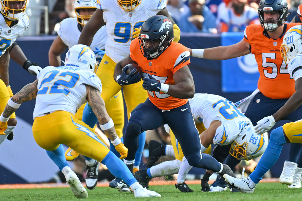 Broncos running back Audric Estime (23) runs the ball during a game between the Denver Broncos and the Los Angeles Chargers on October 13, 2024, at Empower Field at Mile High in Denver, CO.