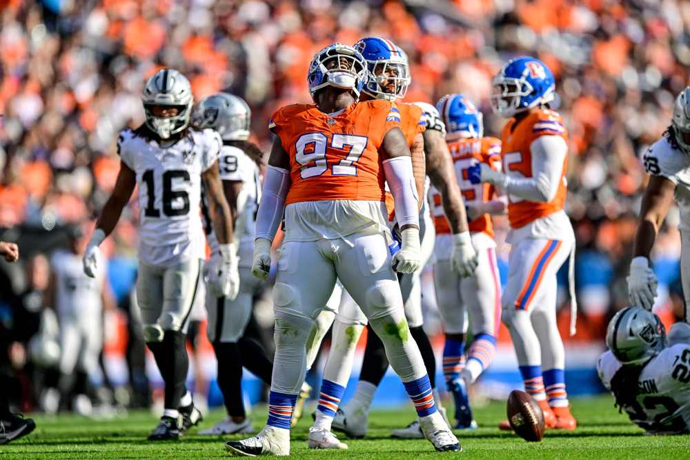 Denver Broncos defensive tackle Malcolm Roach (97) celebrates after a defensive play during a game between the Las Vegas Raiders and the Denver Broncos at Empower Field at Mile High on October 6, 2024 in Denver, Colorado. 