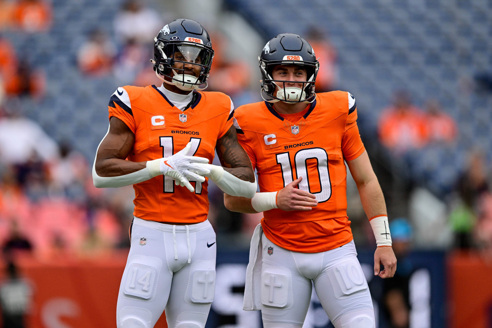 Denver Broncos wide receiver Courtland Sutton (14) and quarterback Bo Nix (10) look on before a game between the Carolina Panthers and the Denver Broncos at Empower Field at Mile High on October 27, 2024 in Denver, Colorado.