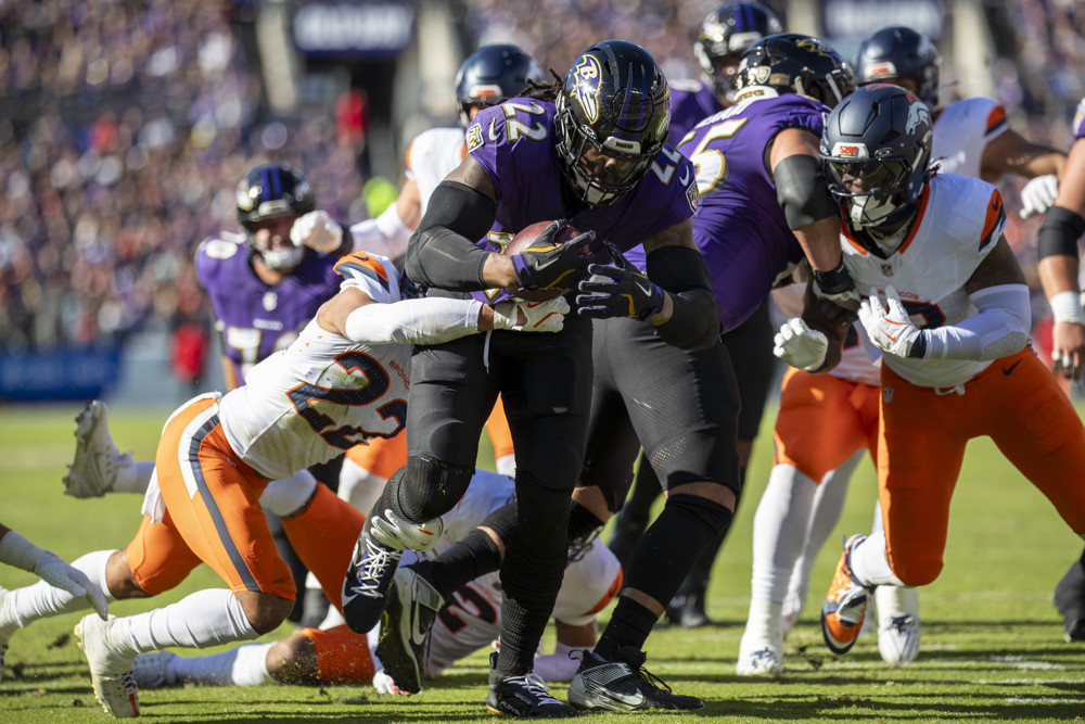 Baltimore Ravens running back Derrick Henry (22) fights his way into the endzone, scoring his 100th career touchdown during the NFL game between the Denver Broncos and the Baltimore Ravens on November 3, 2024, at M&T Bank Stadium in Baltimore, MD.