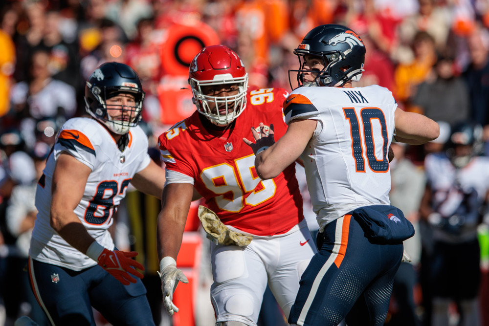 Denver Broncos quarterback Bo Nix (10) looks to pass around Kansas City Chiefs defensive tackle Chris Jones (95) on November 10th, 2024 at GEHA Field Arrowhead Stadium in Kansas City, Missouri