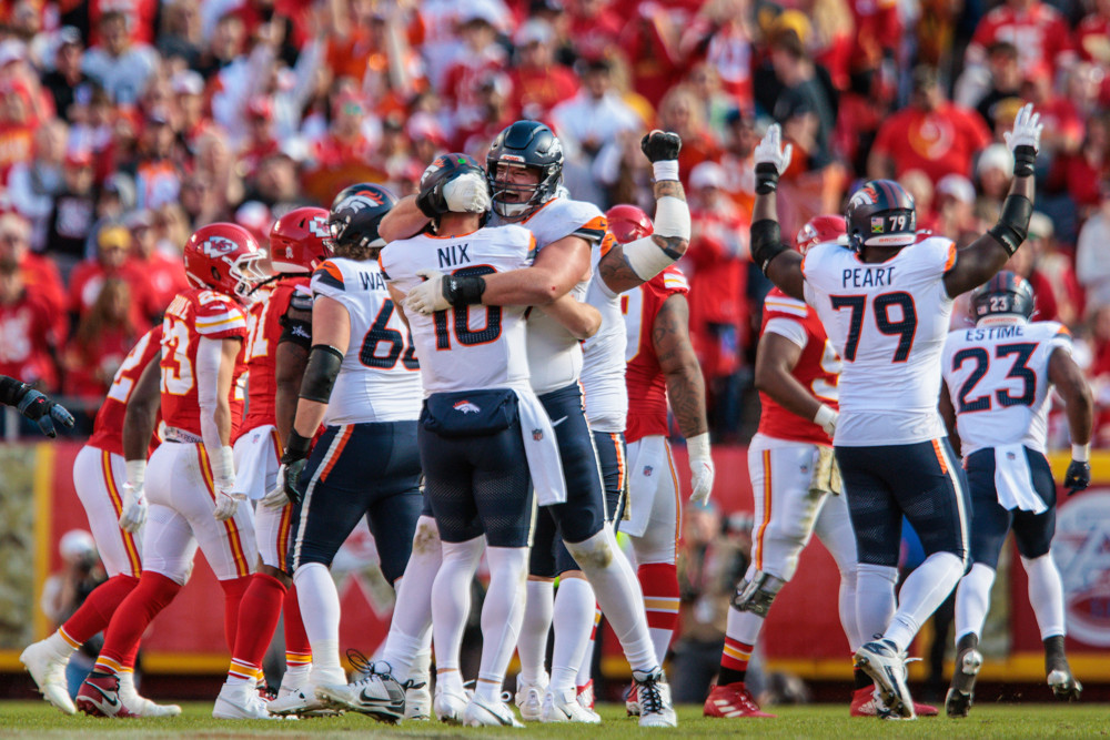 Denver Broncos offensive tackle Mike McGlinchey (69) hugs Denver Broncos quarterback Bo Nix (10) after a touchdown against the Kansas City Chiefs on November 10th, 2024 at GEHA Field Arrowhead Stadium in Kansas City, Missouri