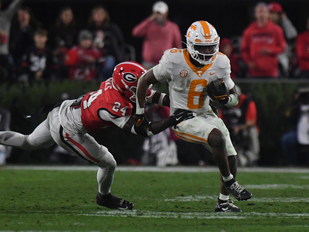 Tennessee Volunteers running back Dylan Sampson (6) rushes the ball as Georgia Bulldogs defensive back Malaki Starks (24) defends during the college football game between the Tennessee Volunteers and the Georgia Bulldogs on November 16, 2024, at Sanford Stadium in Athens, GA. 