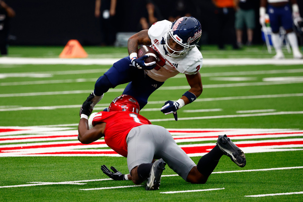 Running back Malik Sherrod (2) of the Fresno State Bulldogs is tackled by defensive back Jalen Catalon (1) of the UNLV Rebels during a Mountain West Conference game between the Fresno State Bulldogs and the UNLV Rebels on September 28, 2024 at Allegiant Stadium in Las Vegas, Nevada.