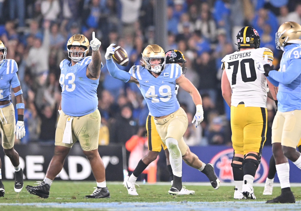 Bruins linebacker Carson Schwesinger (49) recovers a loose ball during the game between Iowa and UCLA on November 08, 2024, at Rose Bowl Stadium in Pasadena, CA.