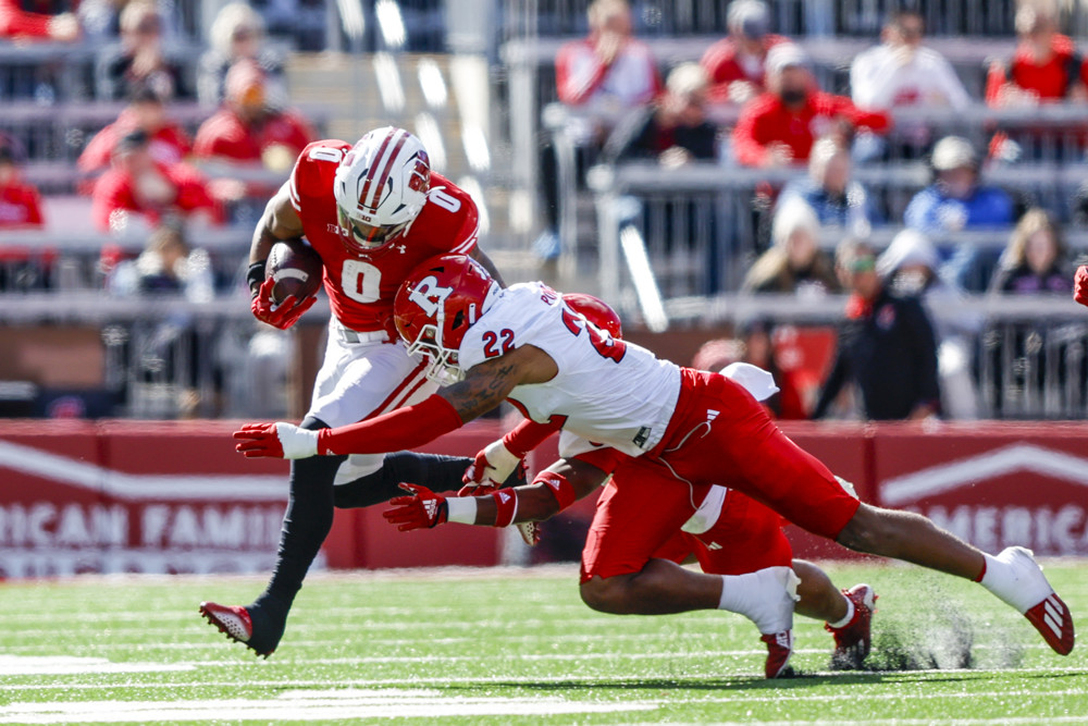 Wisconsin running back Braelon Allen (0) is tackled by Rutgers linebacker Tyreem Powell (22) during a college football game between the University of Wisconsin Badgers and the Rutgers University Scarlet Knights on October 7, 2023 at Camp Randall Stadium in Madison, WI.