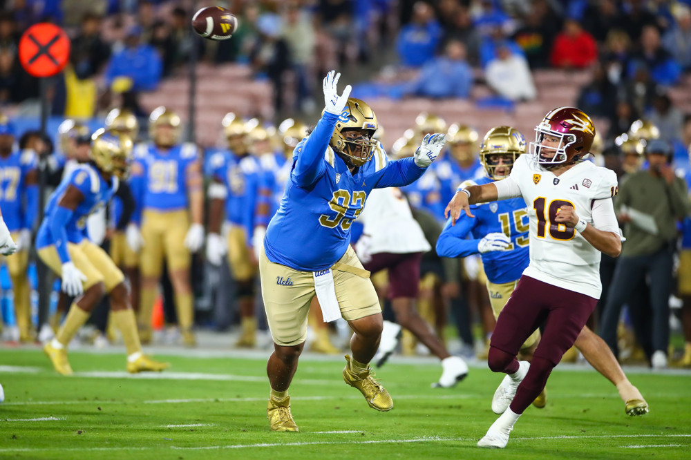 UCLA Bruins defensive lineman Jay Toia (93) applying pressure on Arizona State Sun Devils quarterback Trenton Bourguet (16) during the college football game between the Arizona State Sun Devils and the UCLA Bruins on November 11, 2023, at the Rose Bowl Stadium in Pasadena, CA.