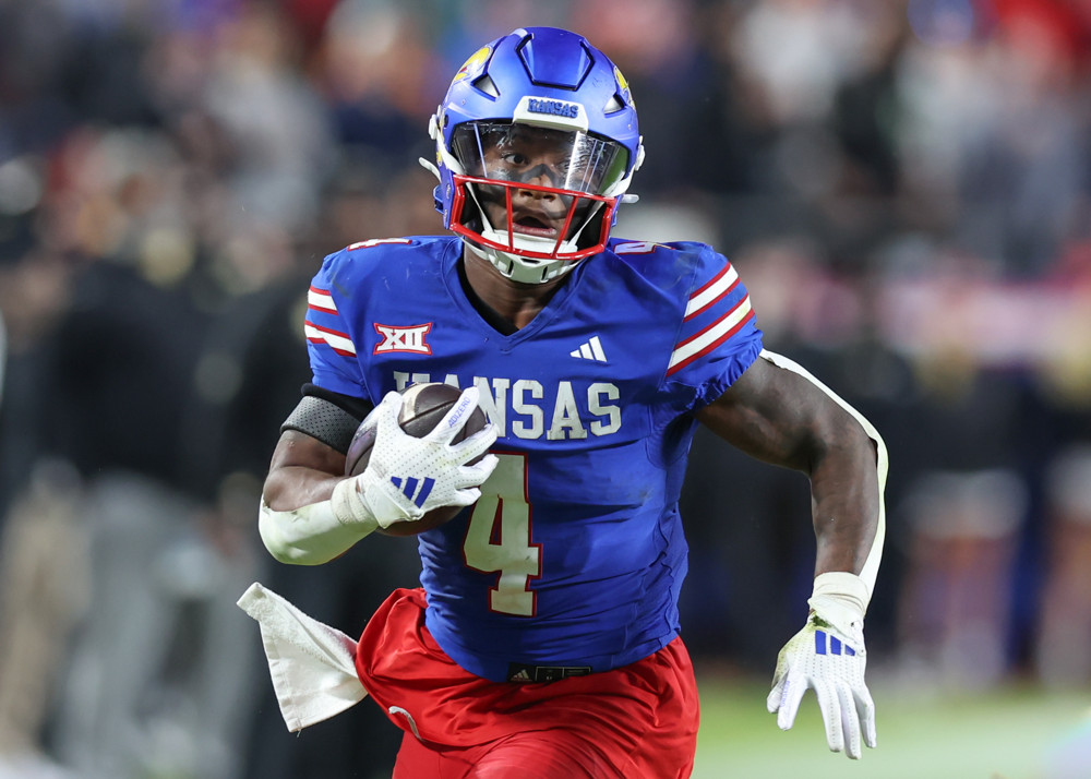 Kansas Jayhawks and senior bowl running back Devin Neal (4) during a carry in the third quarter of a Big 12 game between the Colorado Buffaloes and Kansas Jayhawks on November 23, 2024 at GEHA Field at Arrowhead Stadium in Kansas City, MO.