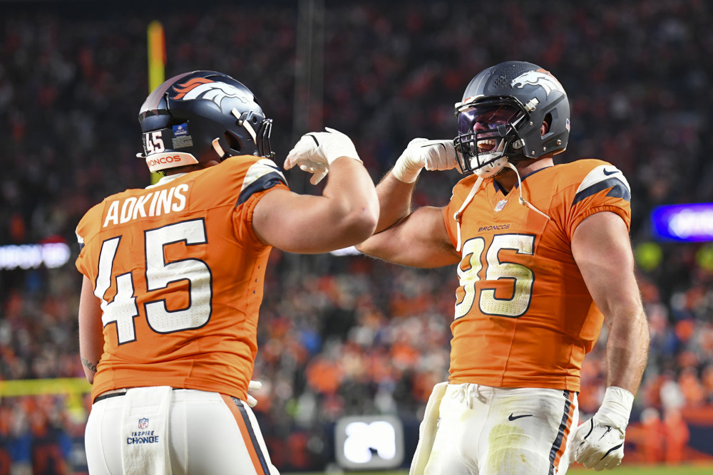 Denver tight end Lucas Krull (85) celebrates with Denver tight end Nate Adkins (45) after Adkins (45) scores a touchdown during a game between the Indianapolis Colts and the Denver Broncos at Empower Field at Mile High in Denver, CO on December 15, 2024.