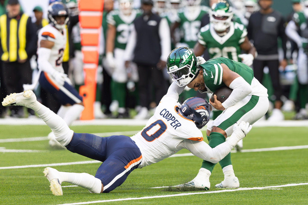 Denver Broncos Linebacker Jonathon Cooper sacks New York Jets Quarterback Justin Fields, ripping his helmet off in the process on October 12, 2025, at Tottenham Hotspur Stadium in London, England.