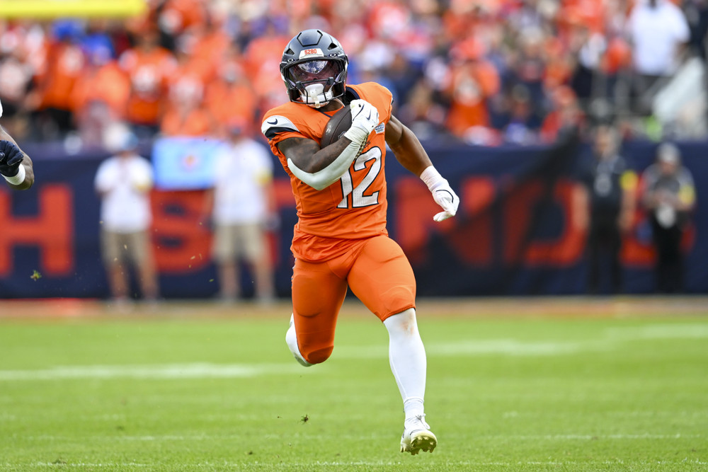 RJ Harvey #12 of the Denver Broncos runs the ball during a game between the Denver Broncos and the Tennessee Titans at Empower Field at Mile High in Denver, CO on September 07, 2025.