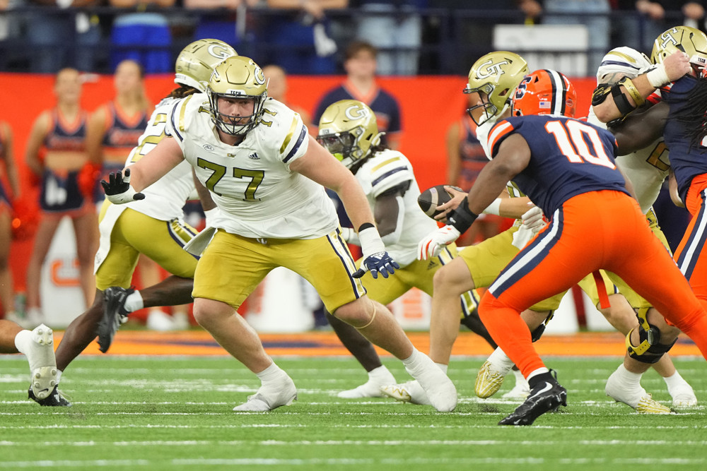 Georgia Tech Yellow Jackets Offensive Lineman Keylan Rutledge (77) looks to block against Syracuse Orange Defensive Lineman Fadil Diggs (10) during the first half of the College Football game between the Georgia Tech Yellow Jackets and the Syracuse Orange on September 7, 2024, at the JMA Wireless Dome in Syracuse, NY.