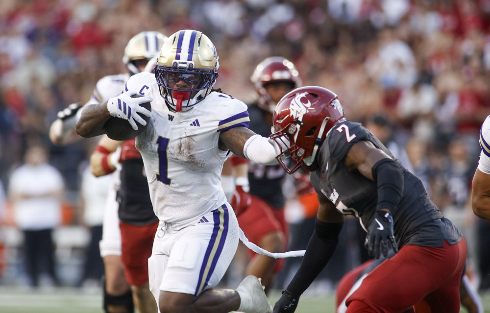 Washington Huskies running back Jonah Coleman (1) reaches out to block Washington State Cougars cornerback Colby Humphrey (2) from tackling him during the game between the Washington Huskies and the Washington State Cougars on September 20, 2025, at Martin Stadium in Pullman, WA.